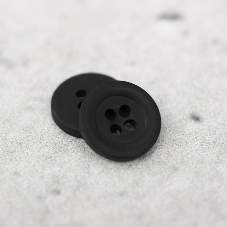 Plastikowy guzik przyszywany na 4 dziurki, o średnicy 1,3 cm.