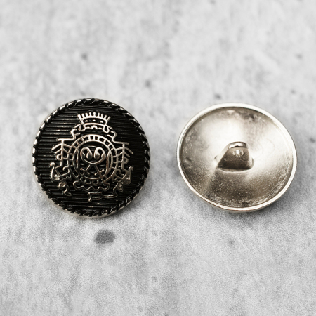 Guzik metalowy na stopce, o średnicy 2,5 cm.