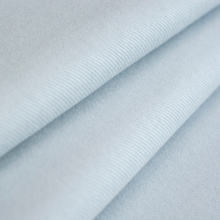 Jeansowa tkanina bawełniana wyróżnia się diagonalną fakturą i jednolitym kolorem.