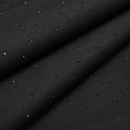 Tkanina Cannes Kamień to elegancka tkanina ubraniowa o diagonalnym splocie, ozdobiona drobnymi, czarnymi cyrkoniami.